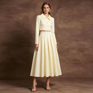 Elegant French vintage two-piece set featuring a cropped jacket and a pleated skirt.
