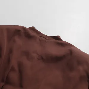 Detailed view of the back collar and fabric texture of a brown satin-finish blazer