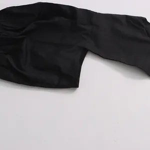 Close-up detail of black puff sleeve blouse showing fabric texture and gathered stitching