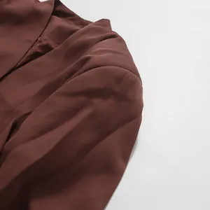 Close-up of the smooth brown fabric and shoulder seam of an elegant American style blazer.