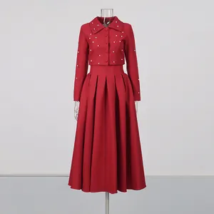 Elegant red two-piece set featuring a pearl cropped jacket and pleated midi skirt