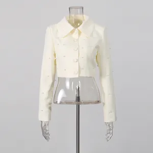 Front view of a French style cream cropped jacket with elegant pearl embellishments