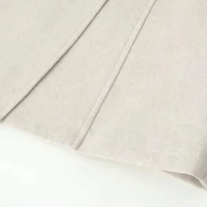 Macro view of apricot linen fabric texture and professional precise vertical stitching detail