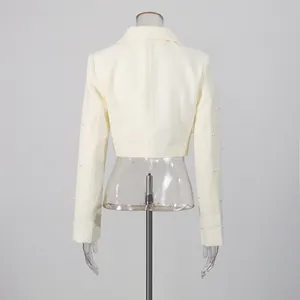 Rear view of French style ivory cropped blazer with delicate pearl embellishments.