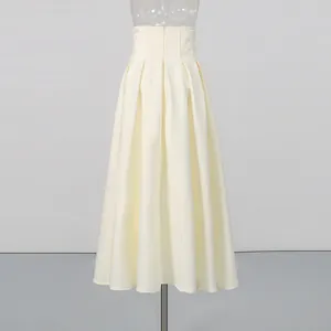 Back view showing the zipper detail of a high-waisted cream pleated midi skirt