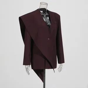 Detailed view of women's burgundy blazer featuring an asymmetrical scarf collar design