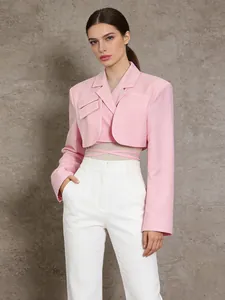 Chic pink cropped blazer with waist tie paired with high-waisted white trousers look