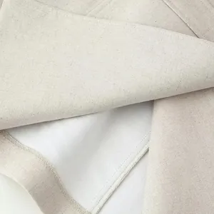 Close-up detail of apricot vest dress showing premium linen fabric and white inner lining.