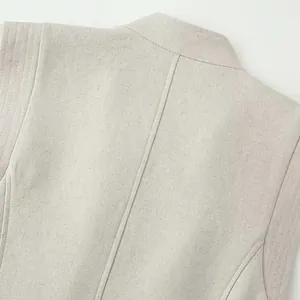 Detailed view of the stand collar and linen fabric texture on this elegant apricot vest dress