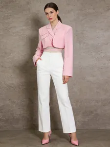 Elegant pink cropped blazer paired with white high-waist trousers for a modern look