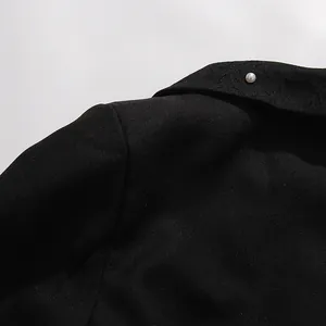 Macro detail of a high-end black vintage top featuring fabric texture, pearl, and lace