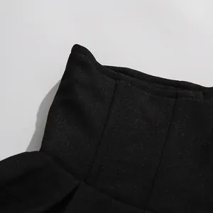 Macro detail of high-waisted black skirt fabric showing high-quality twill texture