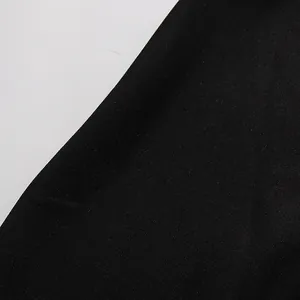 Close-up macro detail showing the fine texture of black fabric for vintage women's set