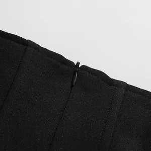 Close-up macro detail of an invisible zipper on a black vintage style high-waisted skirt