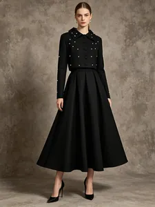 Elegant black two-piece set with pearl-beaded jacket and pleated maxi skirt