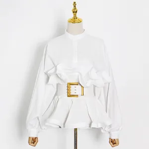 Elegant white long-sleeved ruffled blouse featuring a stylish gold buckle waist belt