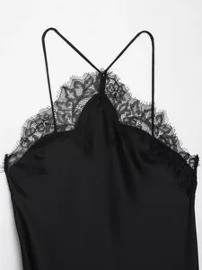 High-detail shot of black satin halter dress with intricate eyelash lace neckline