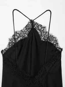 Detailed macro shot of a black French style halter dress with intricate lace trim