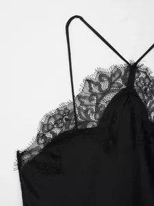 Close-up of elegant black lace and eyelash trim detail on a French style silk slip dress