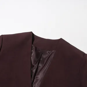 Macro detail of burgundy blazer neckline showing smooth texture and satin lining