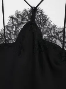 Close-up shot of black eyelash lace detail on elegant silk-like halter neck dress