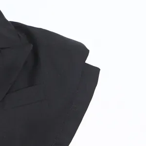 Close-up detail of a black biker style vest featuring notched lapels and fine fabric.