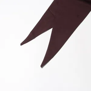 Detailed macro view showing the pointed tip and fabric texture of a burgundy streamer blazer
