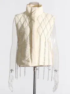 Detail view of cream puffer vest featuring elegant rhinestone fringe and diamond pattern