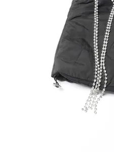 Detail view of black quilted vest featuring elegant sparkling rhinestone tassel fringes.