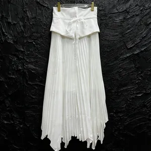 Detail view of a white high-waist pleated skirt with drawstring and irregular hemline