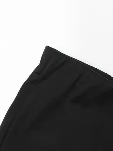 Close-up of black high-waisted flared trousers waist and fabric texture
