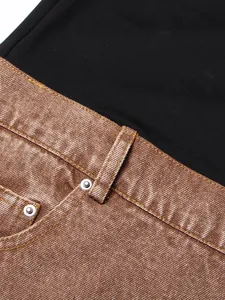 Close-up of high-waist flared jeans featuring bronze metallic finish and black contrast