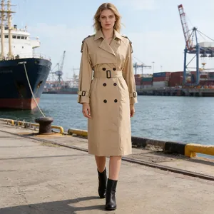 Classic khaki double-breasted trench coat for women in a scenic harbor setting
