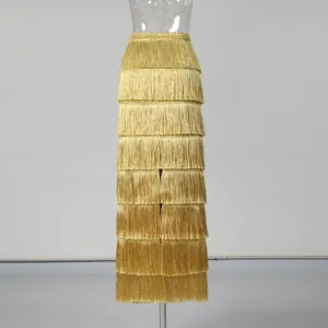 Detailed view of elegant gold high-waist fringed tiered skirt with layered tassels