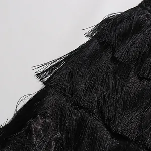 Detailed macro view of black multi-layered fringe tassels on a vintage-style tiered skirt