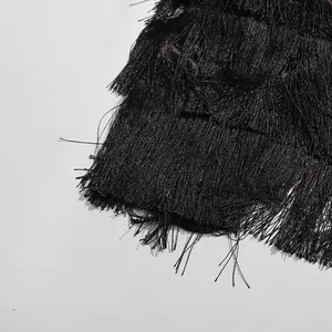 Close-up detail of black layered tassel fringes on an elegant cake skirt style