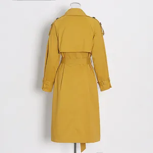 Detailed back view of a mustard yellow long-sleeved trench coat with a matching waist belt.
