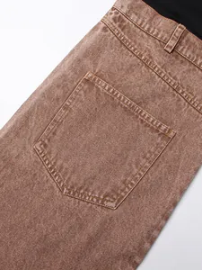 Close-up of back pocket detail on high-waist brown mineral wash denim jeans for women.