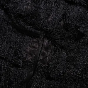 Close-up detail showing the dense black fringe texture of the vintage tassel cake skirt.