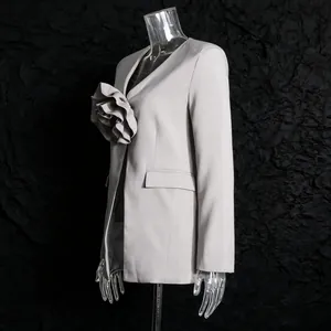 Close-up of elegant grey blazer with 3D flower detail on textured black background