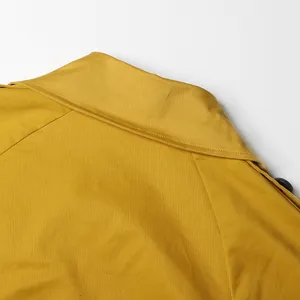 Detail shot of the refined lapel collar on a mustard yellow French style trench coat