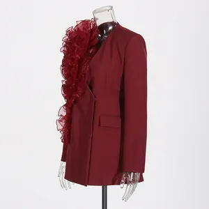 Side view of elegant burgundy blazer featuring dramatic ruffle detail on transparent mannequin