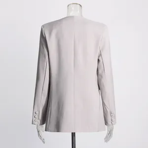 Detailed back view of a high-quality women's light grey blazer on a clear mannequin