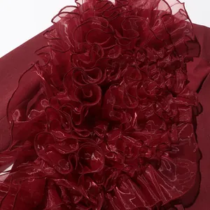Detail shot of wine red blazer with elegant layered ruffle stitching on the front