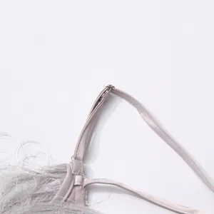 Close-up detail of silver satin shoulder strap with metal ring on a sexy fringe top
