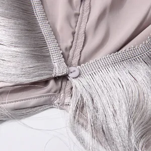Detailed view of the button closure and elegant fringes on a purple summer halter top