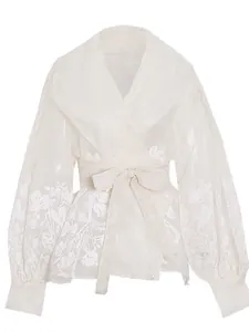 Elegant French style white organza wrap blouse featuring floral prints and a waist tie