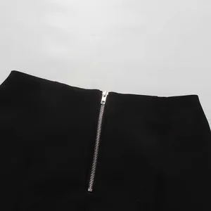 Close-up of the metal back zipper on an elegant black vintage high-waisted pencil skirt.