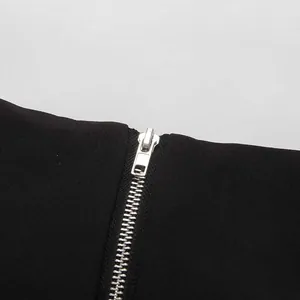 Close-up detail of silver metal zipper on an elegant black high-waisted pencil skirt.