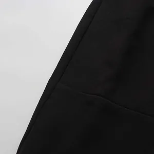 Detailed view of the premium black fabric texture and neat stitching of an elegant midi skirt